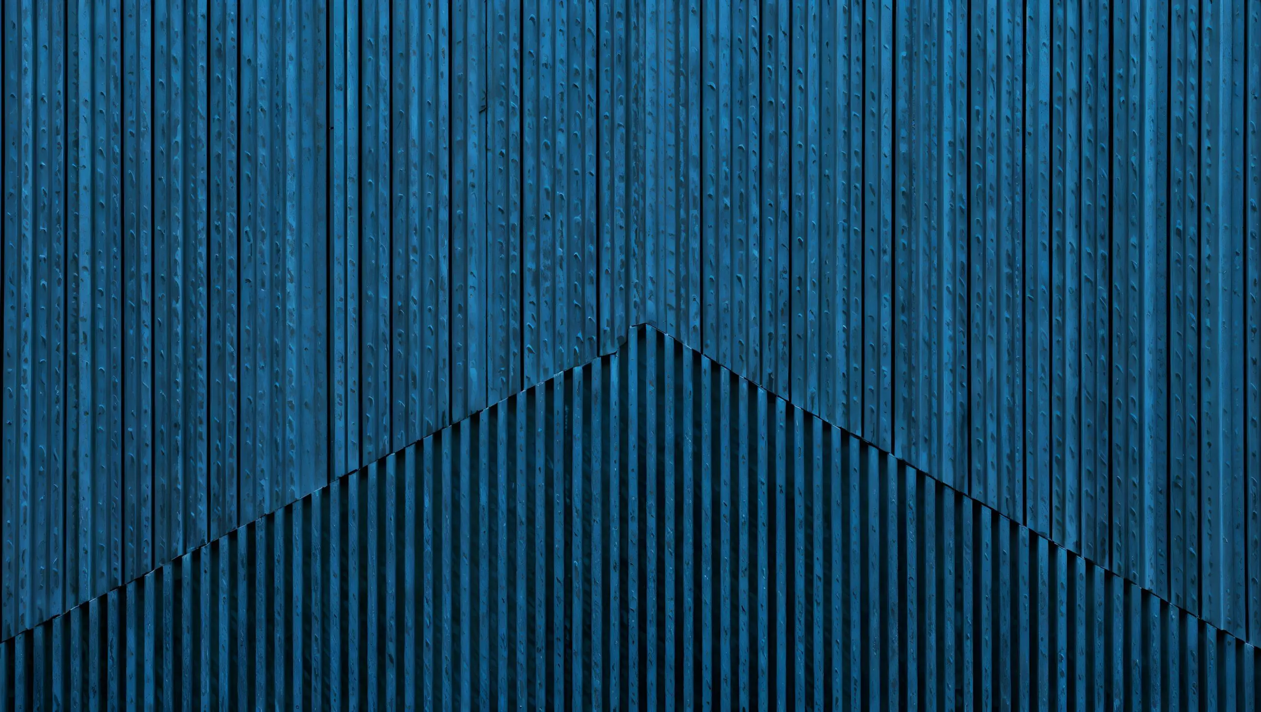 Dark blue vertical wooden planks with a subtle v shape pattern