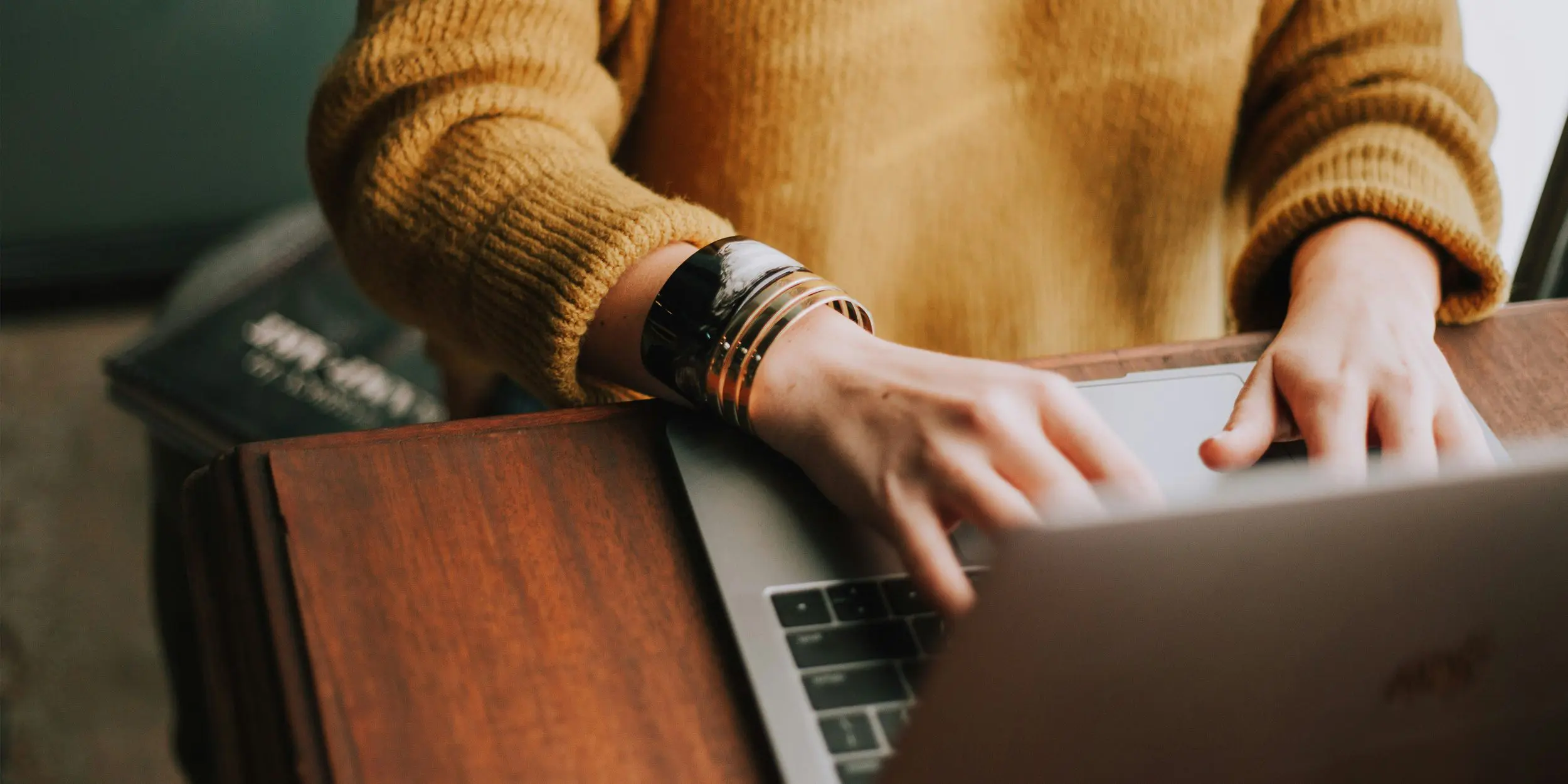 photo of student typing on a laptop